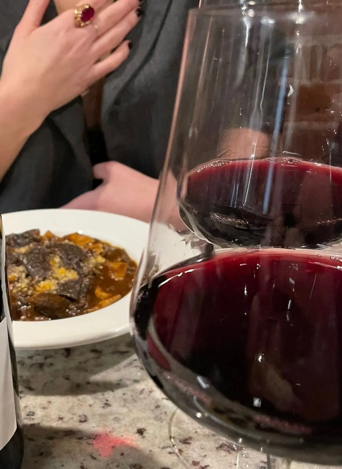 Red wine glasses with seasonal dish at a natural wine bar